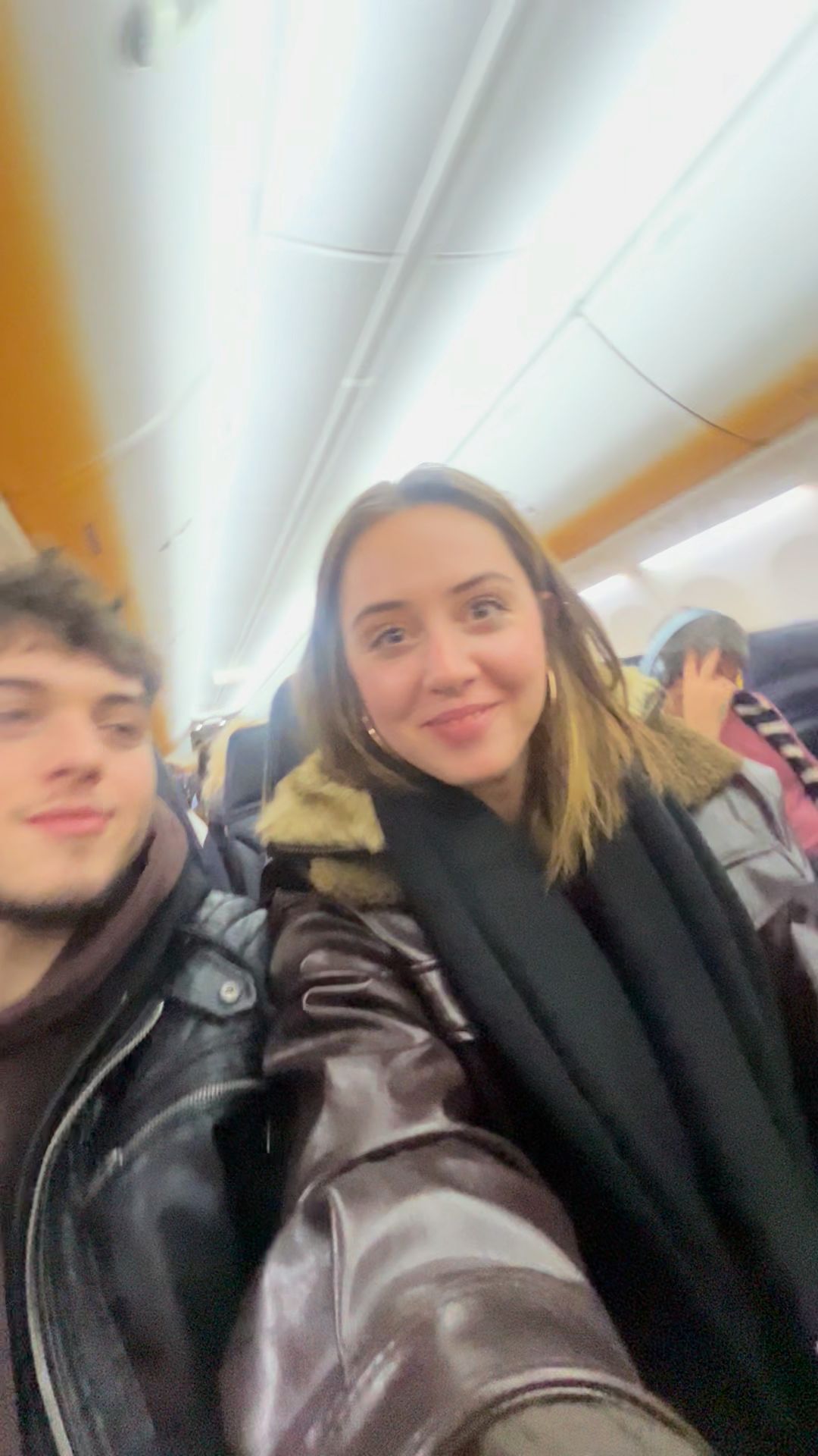 Couple on Airplane Excitedly Waving
